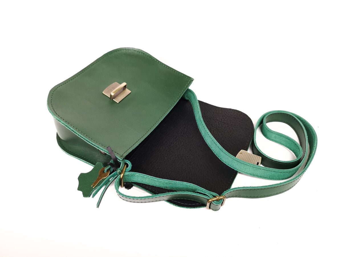6. Open Zelma Kraft green leather saddle bag showing interior and adjustable strap