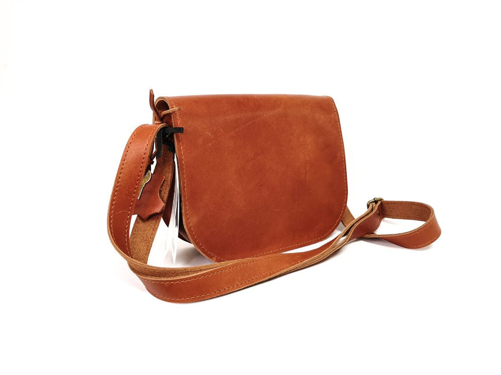 4. Back view of Zelma Kraft light brown leather saddle bag with adjustable strap, shown in studio
