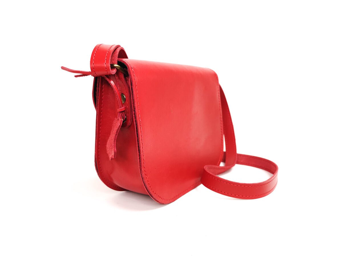 6. Side view of Zelma Kraft red leather saddle bag, showcasing its sleek design and craftsmanship
