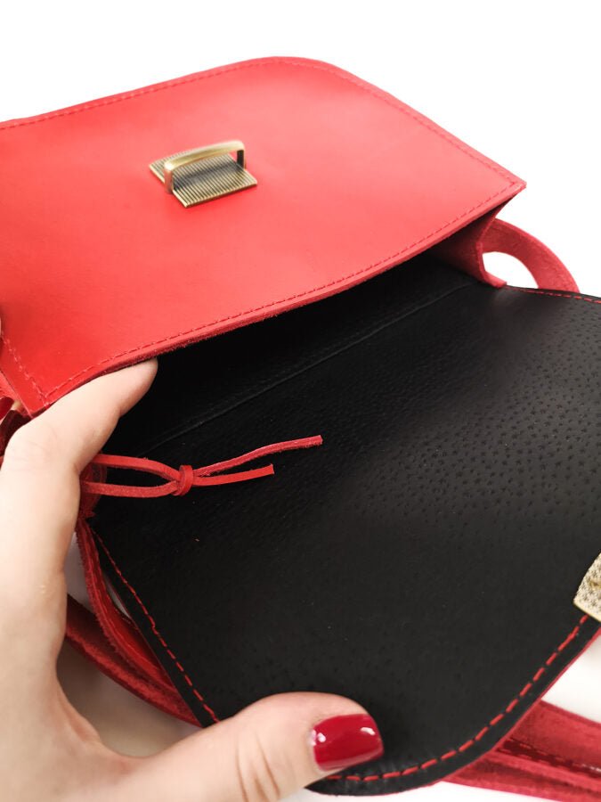 7. Close-up of Zelma Kraft red leather saddle bag interior, showing black lining and internal pocket