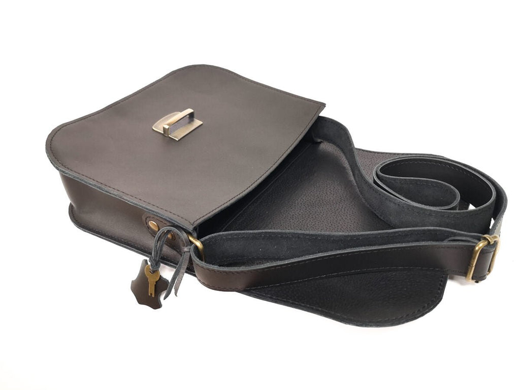 7. Side view of Zelma Kraft black leather saddle bag with open flap and interior details