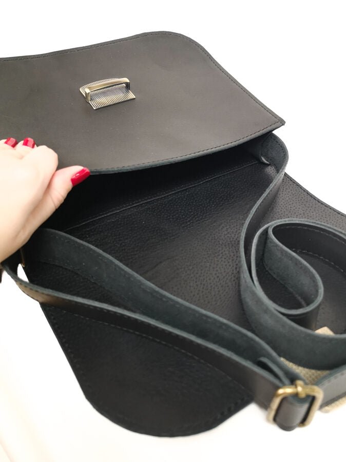 3. Open view of Zelma Kraft black leather saddle bag showing interior and adjustable strap