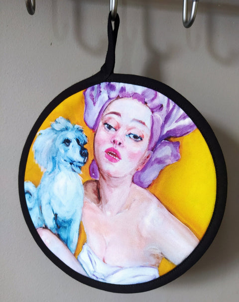 3. Pot holder with pop art design of woman and dog, hanging on a hook, showing vibrant colors
