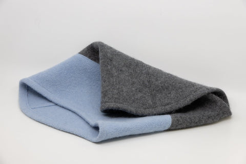 2. Flat lay of HERTTA felted wool tube scarf in medium grey and light blue, showcasing texture and color contrast