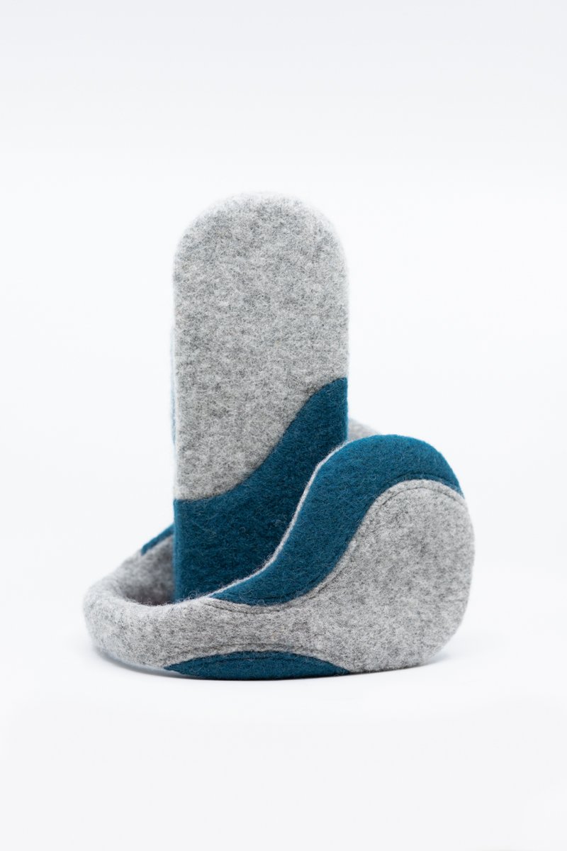 1. Women's felted wool mittens in light grey and aquamarine by HERTTA, shown in studio setting