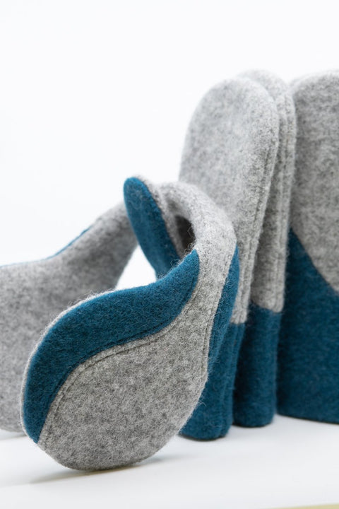 4. Close-up of HERTTA felted wool earmuffs in light grey and aquamarine, highlighting texture and design