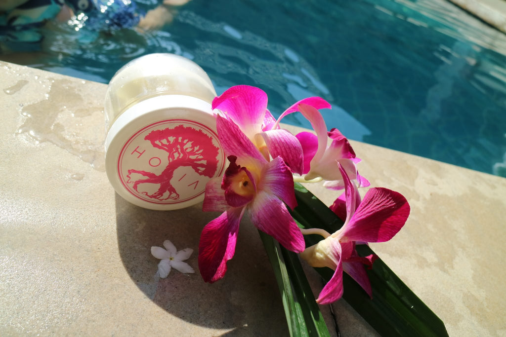3. HOIA homespa Monoi de Tahiti Body Butter jar with pink orchid, poolside setting
