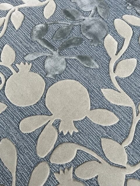 3. Detailed view of pomegranate motif in beige and grey on blue wool rug