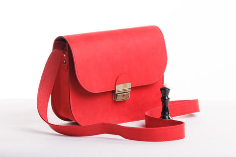 3. Zelma Kraft red natural leather saddle bag with semi-gloss finish, shown with adjustable strap and buckle closure