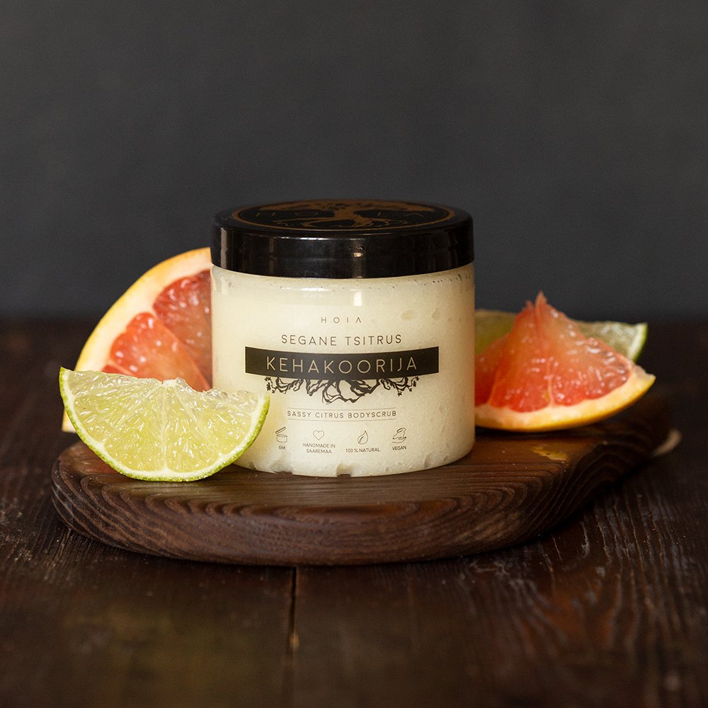 3. HOIA homespa Sassy Citrus body scrub on a wooden board with lime and grapefruit slices, emphasizing natural and eco-friendly skincare