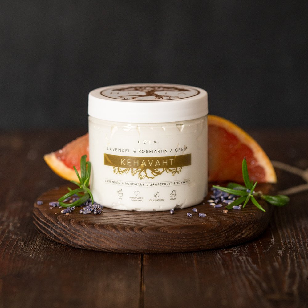 2. HOIA homespa Whipped Body Butter with lavender, grapefruit, and rosemary, displayed on wooden board with grapefruit slice