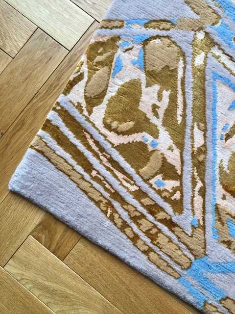 3. Close-up of Art Deco Diagonal Pink Rug corner highlighting gold and blue design on wooden floor