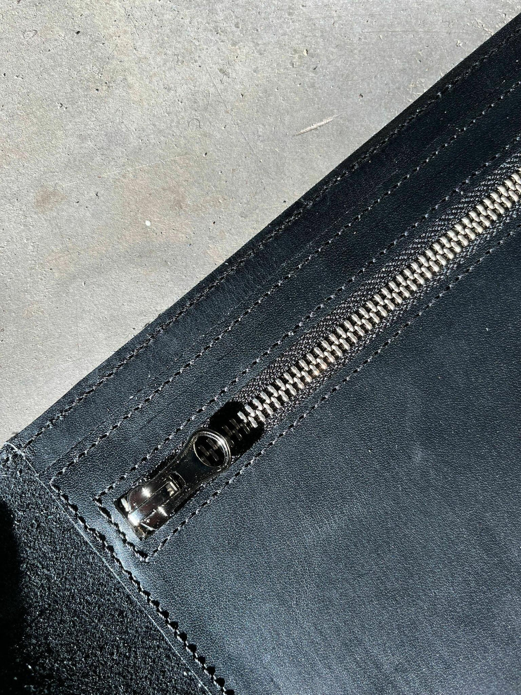 3. Close-up of black leather zipper pocket inside Stella Soomlais handbag