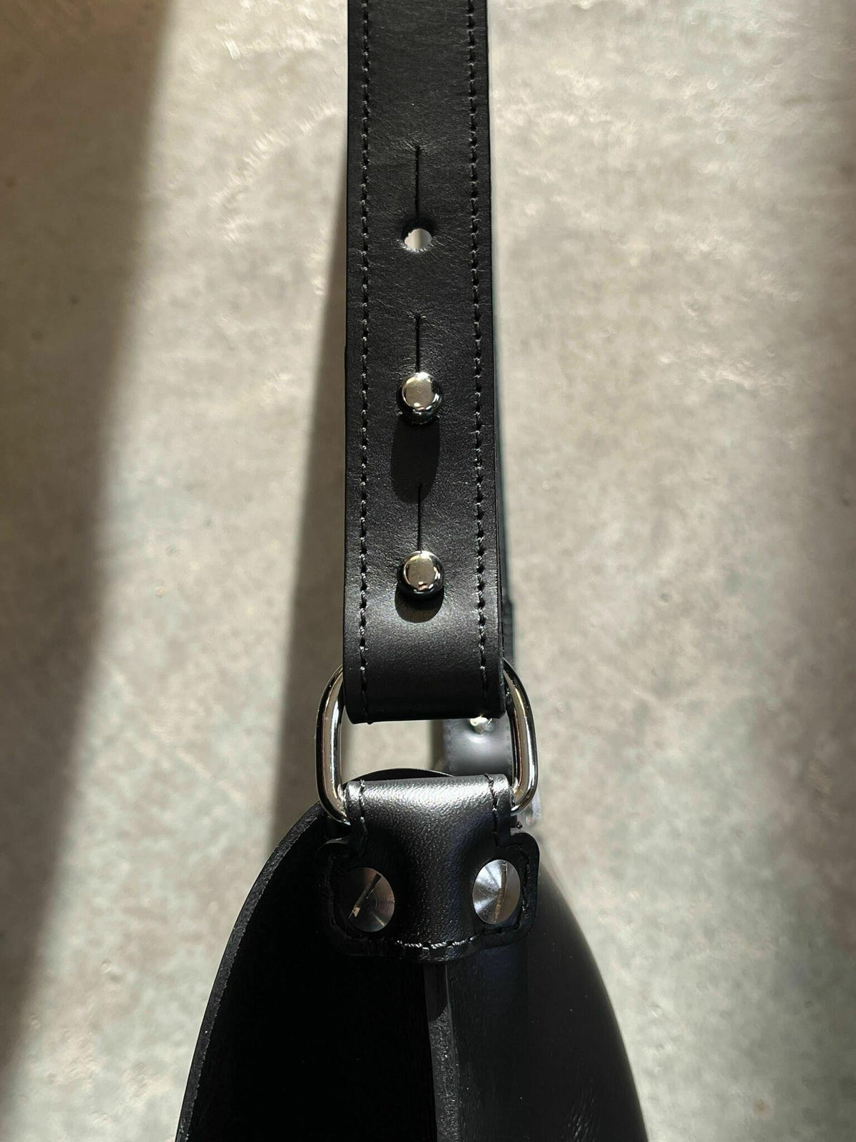 3. Close-up of adjustable black leather strap on Stella Soomlais handbag