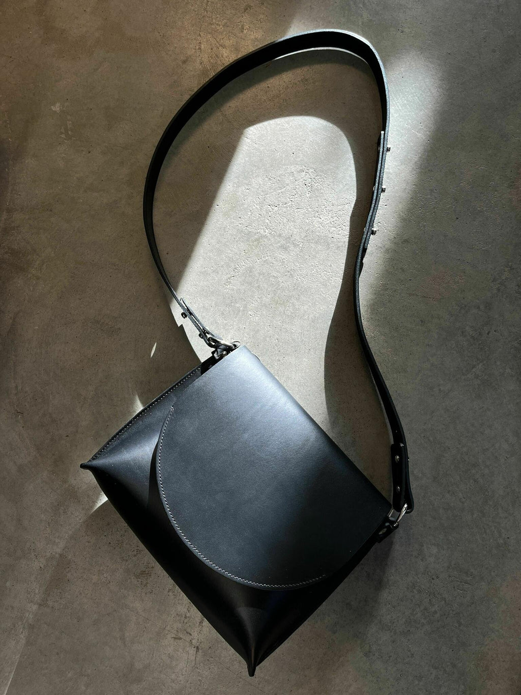 2. Studio shot of Stella Soomlais Undercover Lover handbag with adjustable strap on concrete background