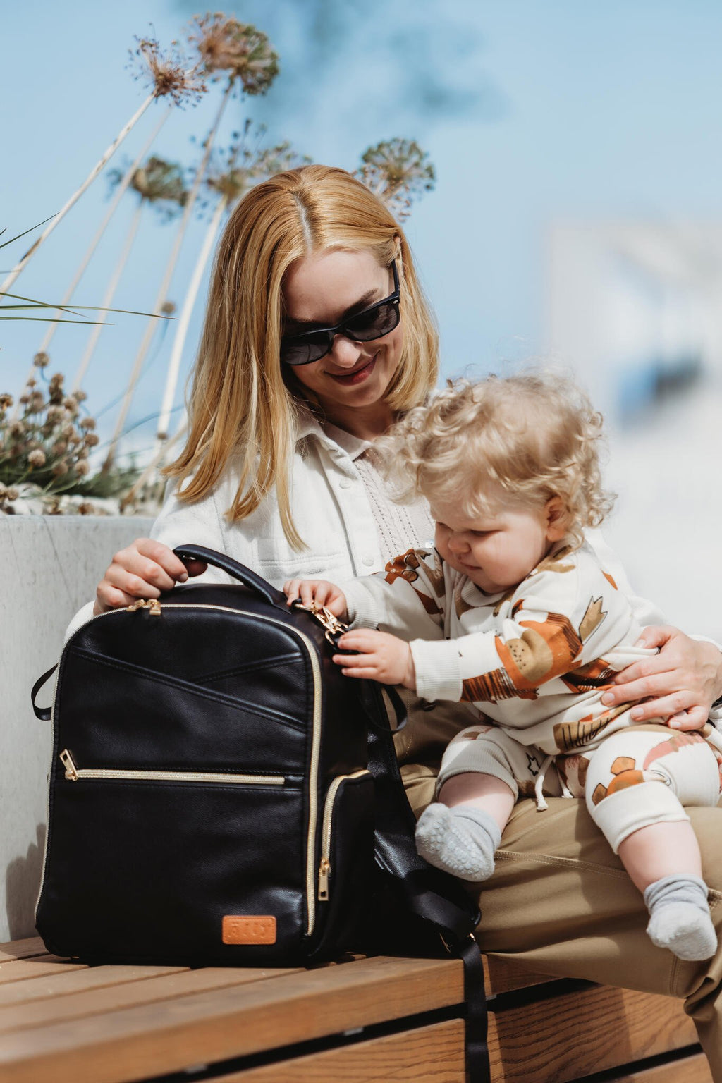 1. Woman with child using Ally Scandic Small Espresso Diaper Backpack outdoors