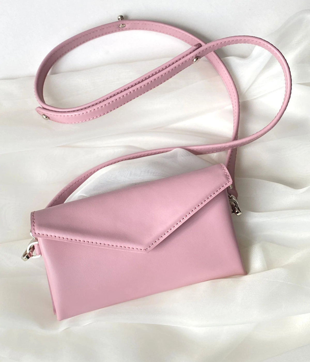 11. Pink leather waist and shoulder bag by Gerda Retter Design, shown on white fabric