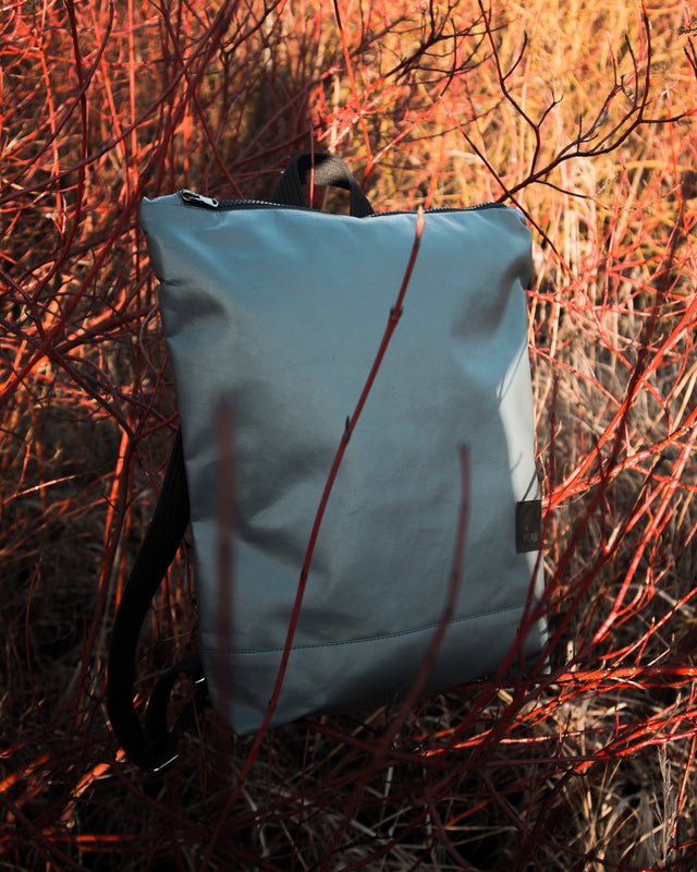 9. Muni faux leather grey backpack displayed in outdoor setting