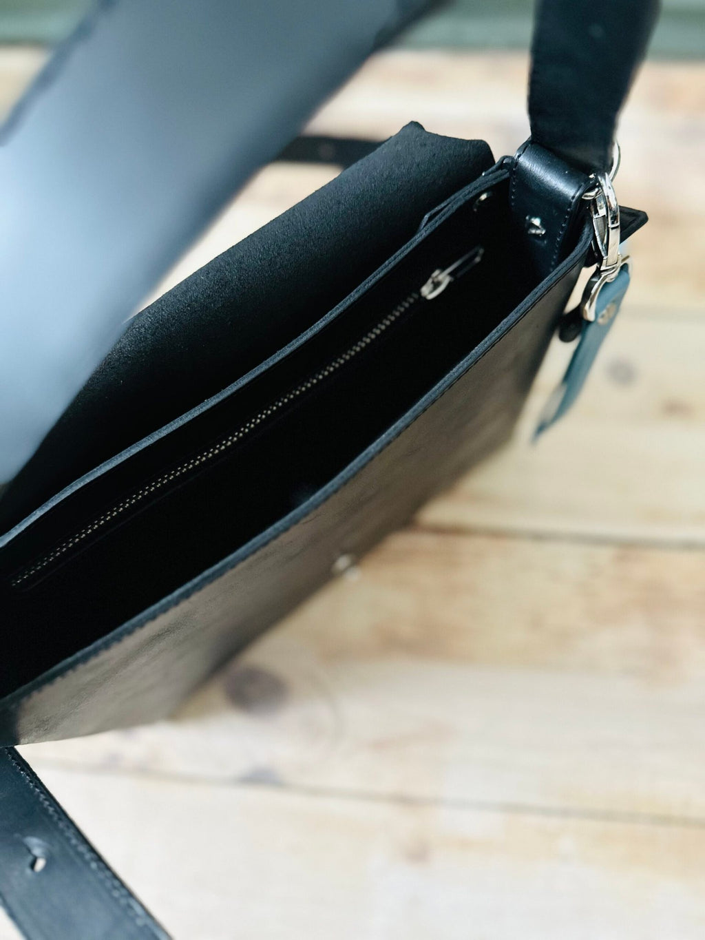 11. Interior view of eleriinseim TOURIST crossbody leather bag in Atlantic blue, showing spacious compartments and zippered pocket