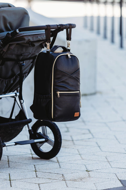 3. Ally Scandic Espresso Diaper Backpack attached to stroller, demonstrating stroller strap feature