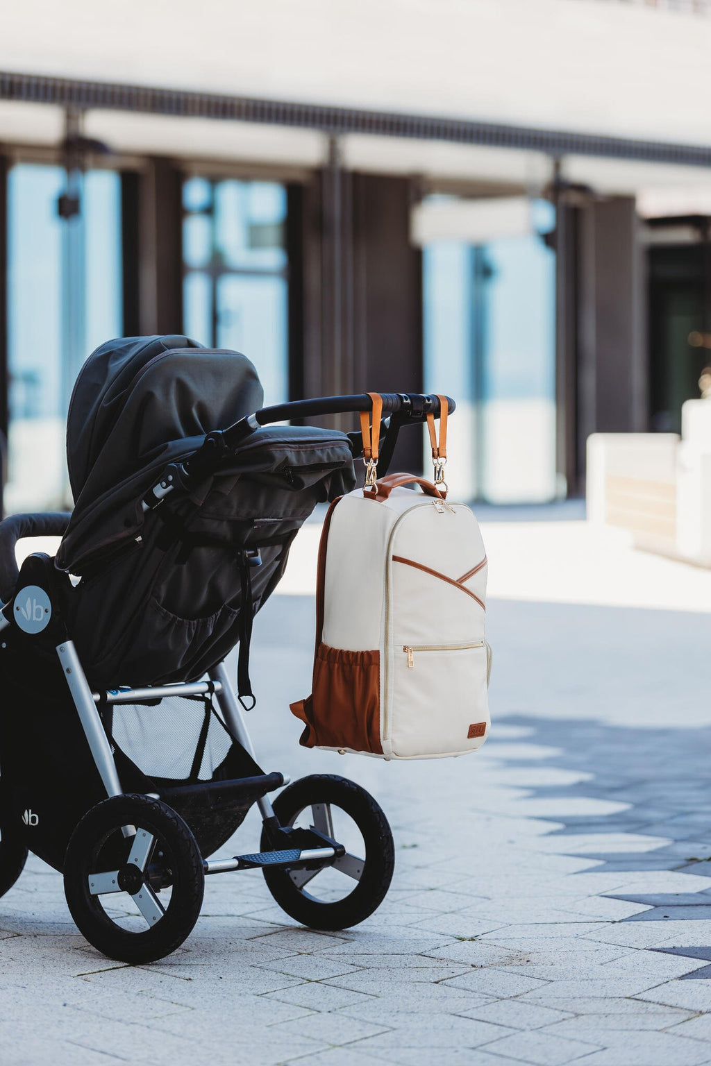 5. Ally Scandic Cappuccino Diaper Backpack attached to stroller, illustrating hands-free use