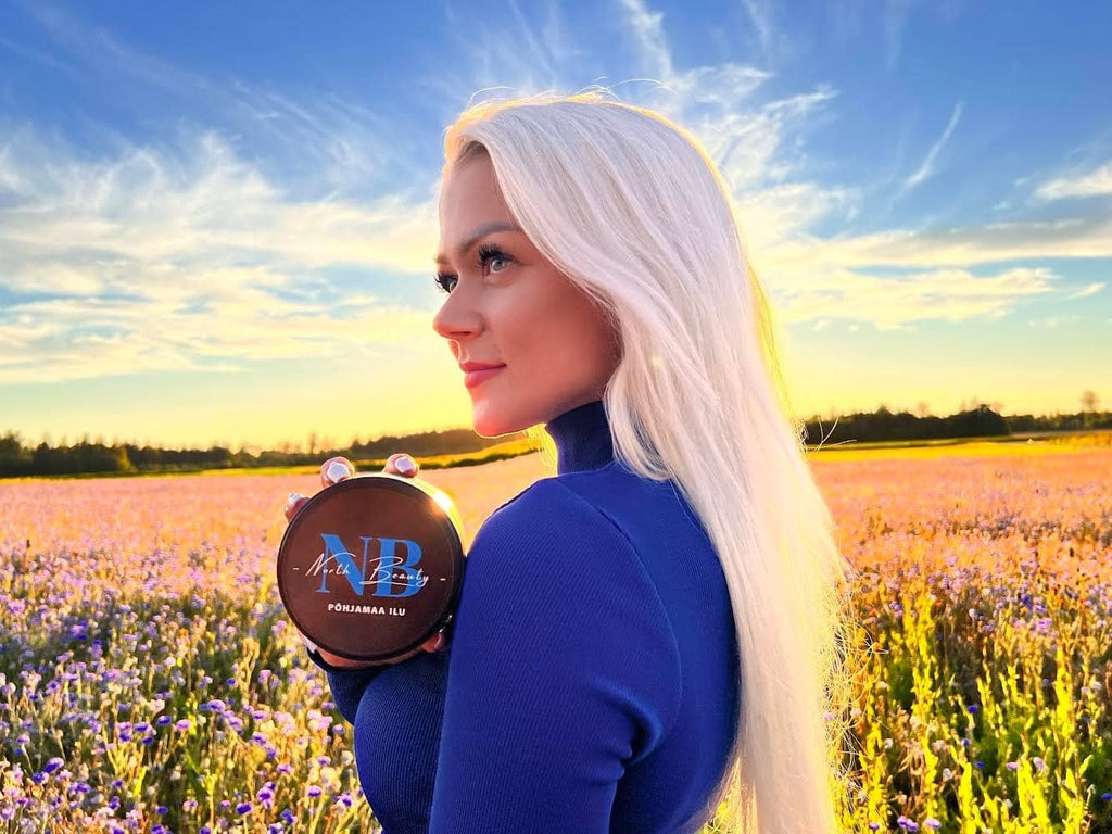 1. Woman holding North Beauty All In One Detergent for Men in a field at sunset