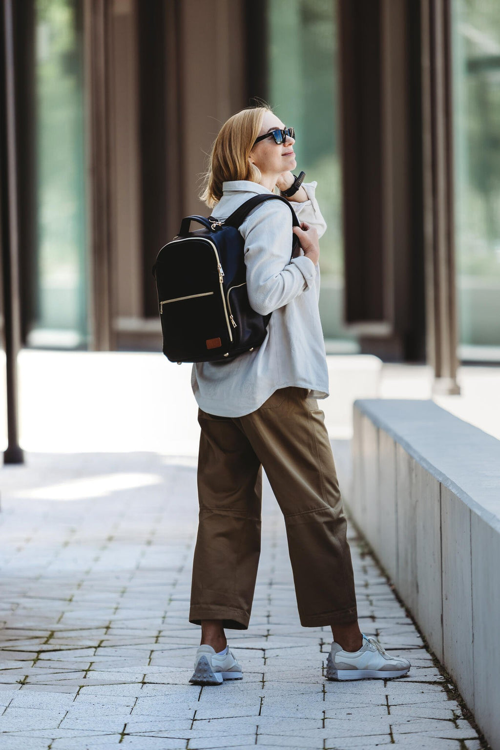 17. Woman wearing Ally Scandic Small Espresso Diaper Backpack while walking