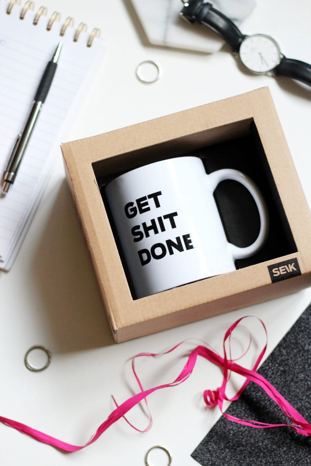 1. SEIK Design Mug with 'GET SHIT DONE' text in gift box, shown in lifestyle setting with office accessories