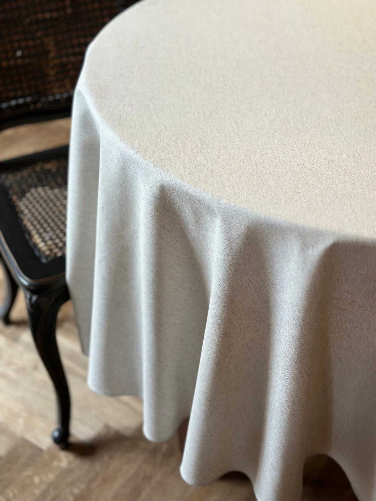 2. Studio shot of Hortensias Home round tablecloth in beige, highlighting recycled fabric and Nordic elegance