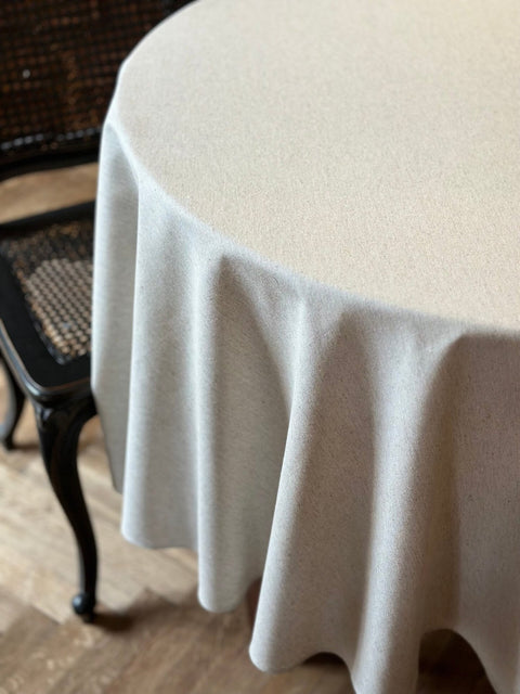 2. Studio shot of Hortensias Home round tablecloth in beige, highlighting recycled fabric and Nordic elegance