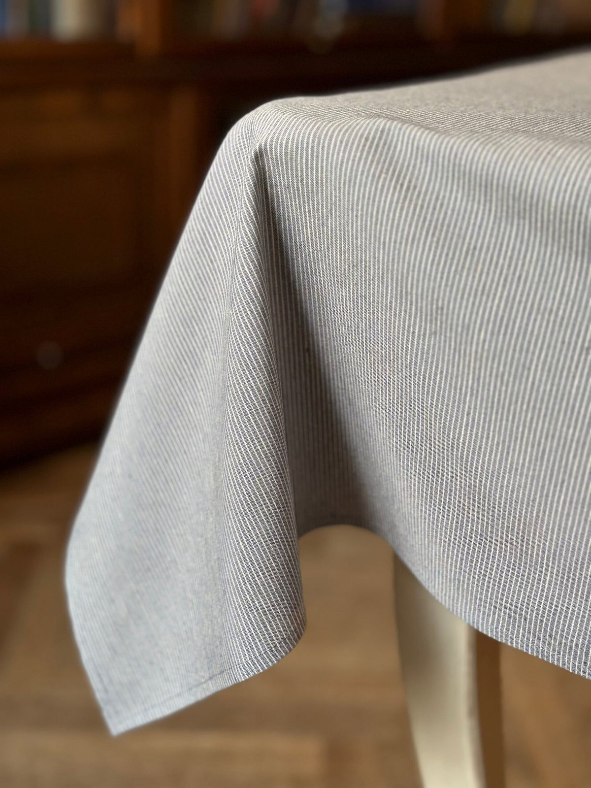 1. Rectangular tablecloth from Nord 2 collection by Hortensias Home, featuring neutral color with blue stripes, draped over a table in a lifestyle setting