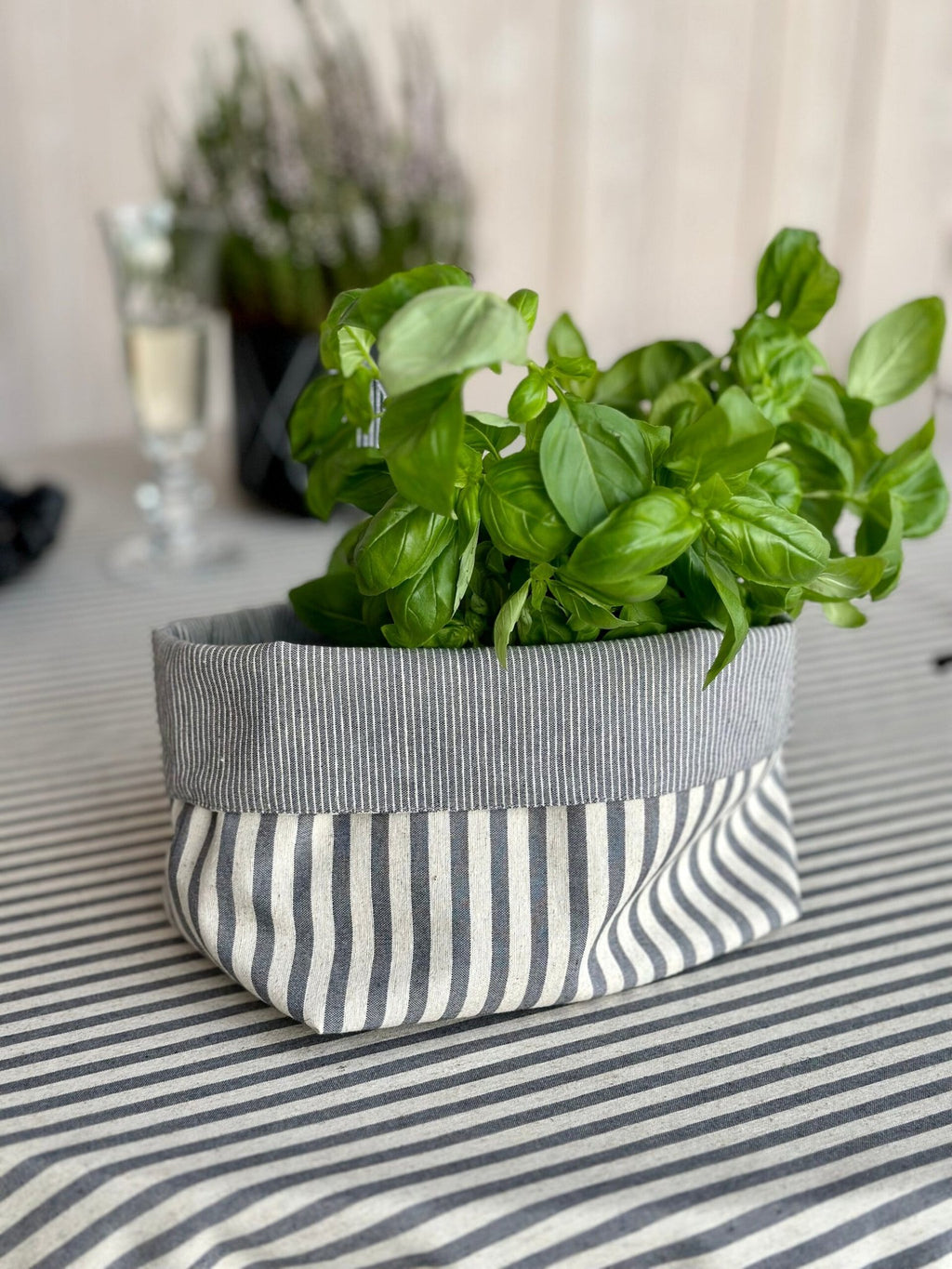 4. Blue striped tablecloth from Nord 1 Collection by Hortensias Home, styled with a plant, highlighting recycled fabric and Nordic charm