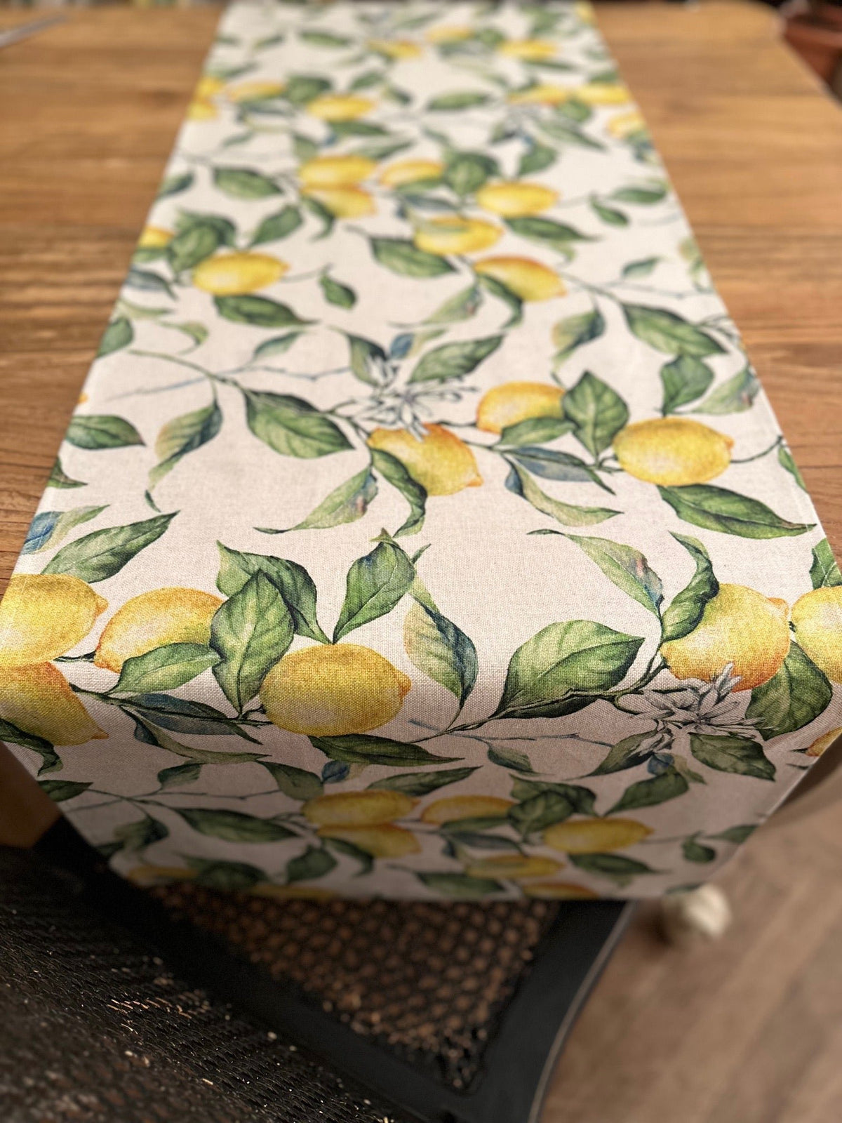 2. Lemon Linen Table Runner by Hortensias Home on wooden table, showcasing vibrant lemon and leaf print