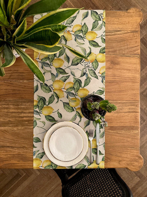 4. Top view of Lemon Linen Table Runner by Hortensias Home on dining table with plant and plate setting
