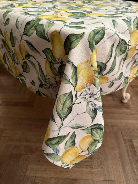 2. Side view of Hortensias Home Lemon Linen tablecloth draped over table, showcasing lemon print