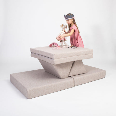 1. Girl playing with toys on beige Monboxy activity play mattress set in studio setting