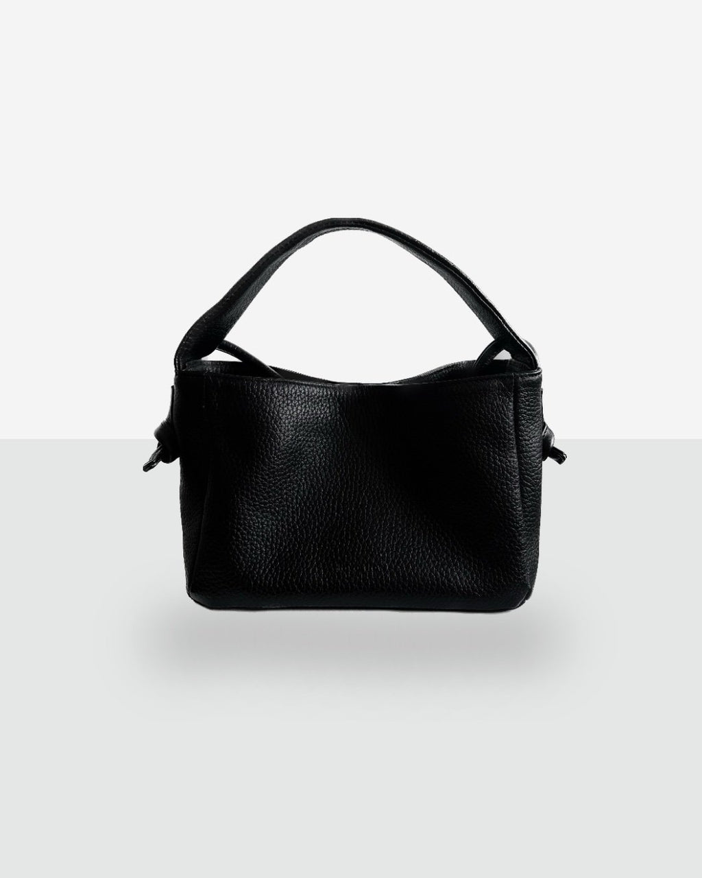 7. Studio shot of Lava Flow Crossbody Bag MERU in black, featuring natural vegetable-tanned leather