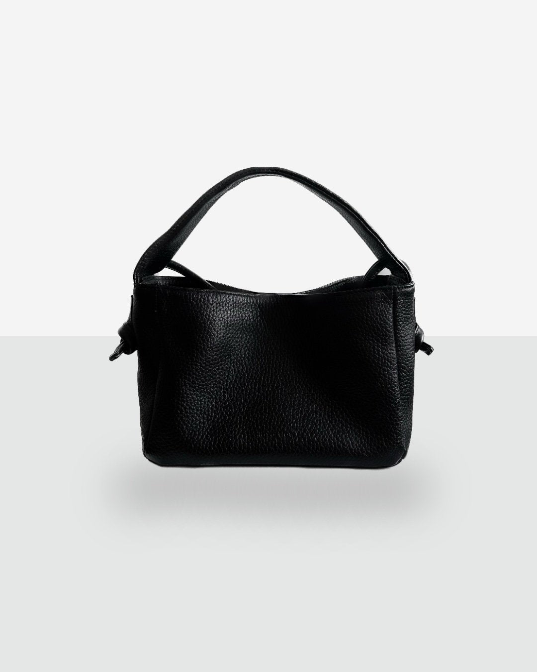 7. Studio shot of Lava Flow Crossbody Bag MERU in black, featuring natural vegetable-tanned leather