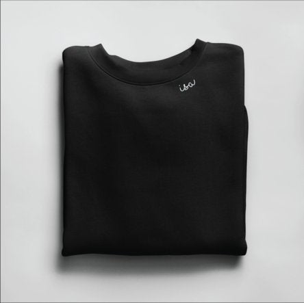 4. Black Beebila sweatshirt with 'Isa' embroidery on collar, folded in studio setting