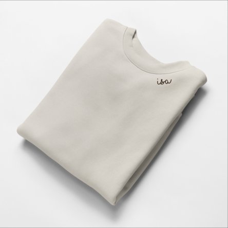 5. Beige Beebila sweatshirt with 'Isa' embroidery on collar, folded in studio setting