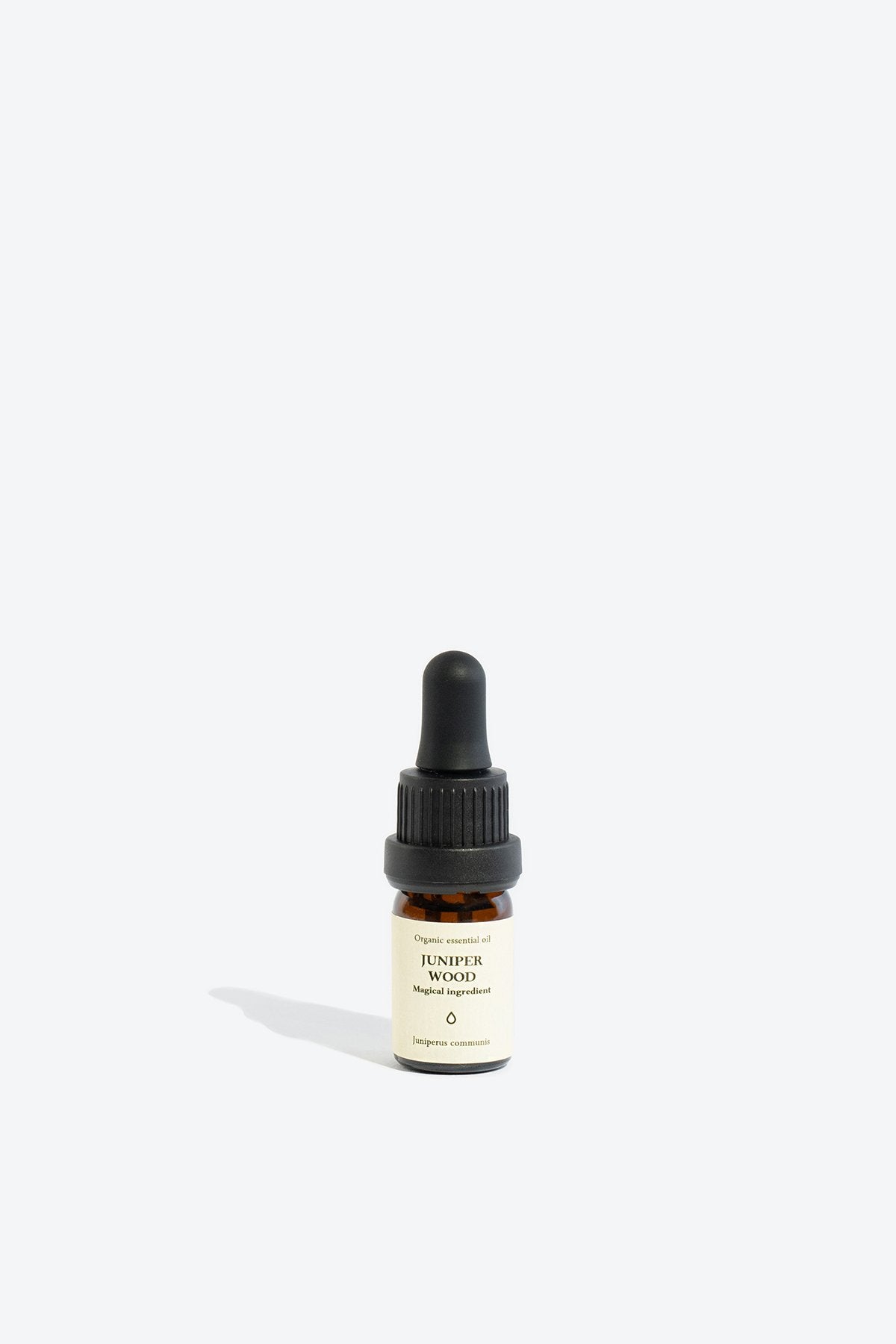 3. Smells Like Spells JUNIPER WOOD Essential Oil in 5 ml glass bottle, studio setting