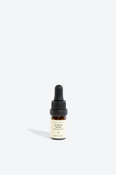 3. Smells Like Spells JUNIPER WOOD Essential Oil in 5 ml glass bottle, studio setting