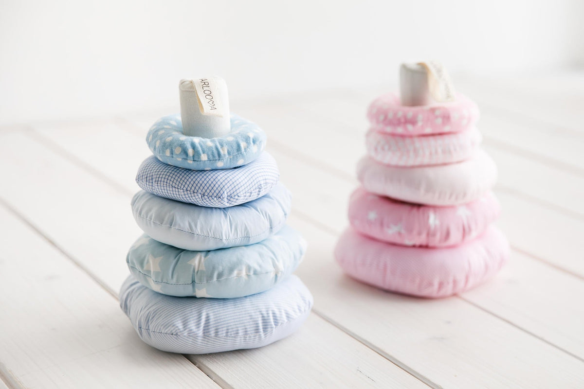 1. Two Karloova baby stacking towers with blue and pink rings on white wooden floor
