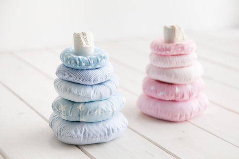 1. Two Karloova baby stacking towers with blue and pink rings on white wooden floor