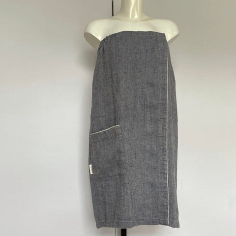 2. Women's grayish blue linen sauna skirt with fishbone pattern displayed on a mannequin in a studio setting
