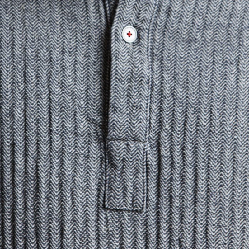 3. Close-up of KOOSdisain dress button detail on black and gray fishbone pattern fabric