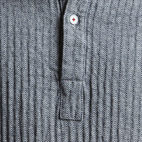 3. Close-up of KOOSdisain dress button detail on black and gray fishbone pattern fabric