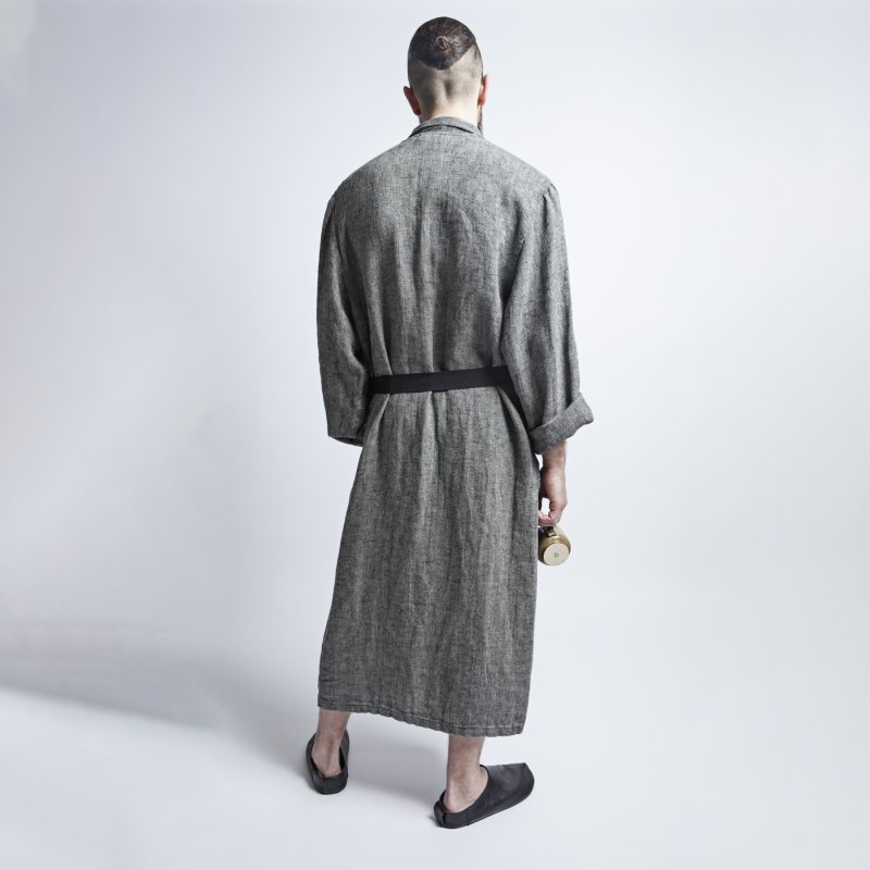 2. Back view of man wearing black fishbone pattern linen bathrobe with black belt in studio