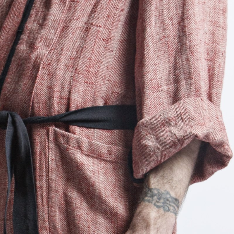 7. Close-up of sleeve and pocket detail on red fishbone pattern linen bathrobe