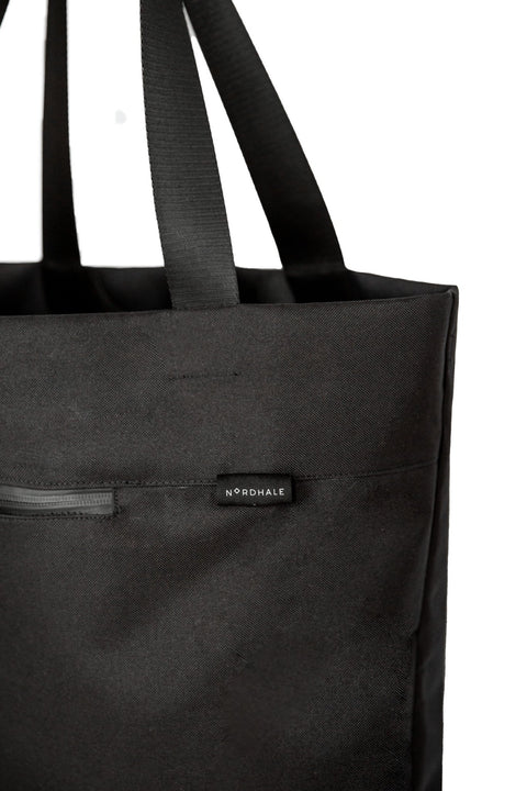4. Close-up of Nordhale VIK Tote Bag in black, focusing on the brand logo and zipper detail